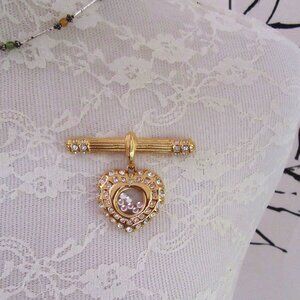 NOLAN MILLER gold tone bar brooch or pendant with floating rhinestone heart